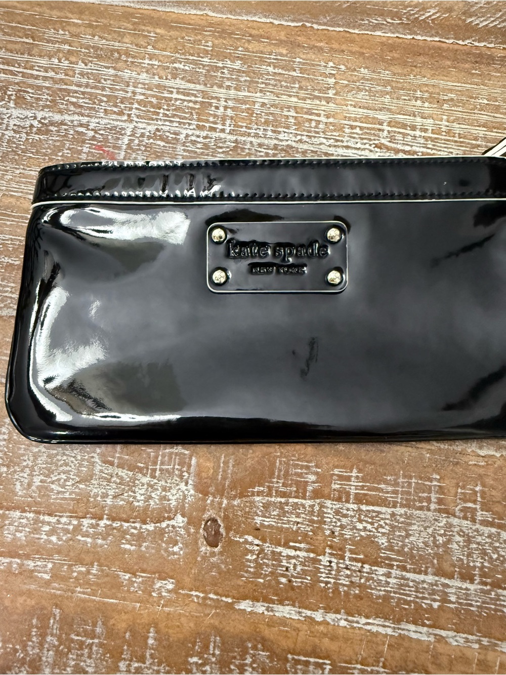 Kate Spade Black Patent Leather Zip Wristlet, 8 1/2” x 4 1/2”.